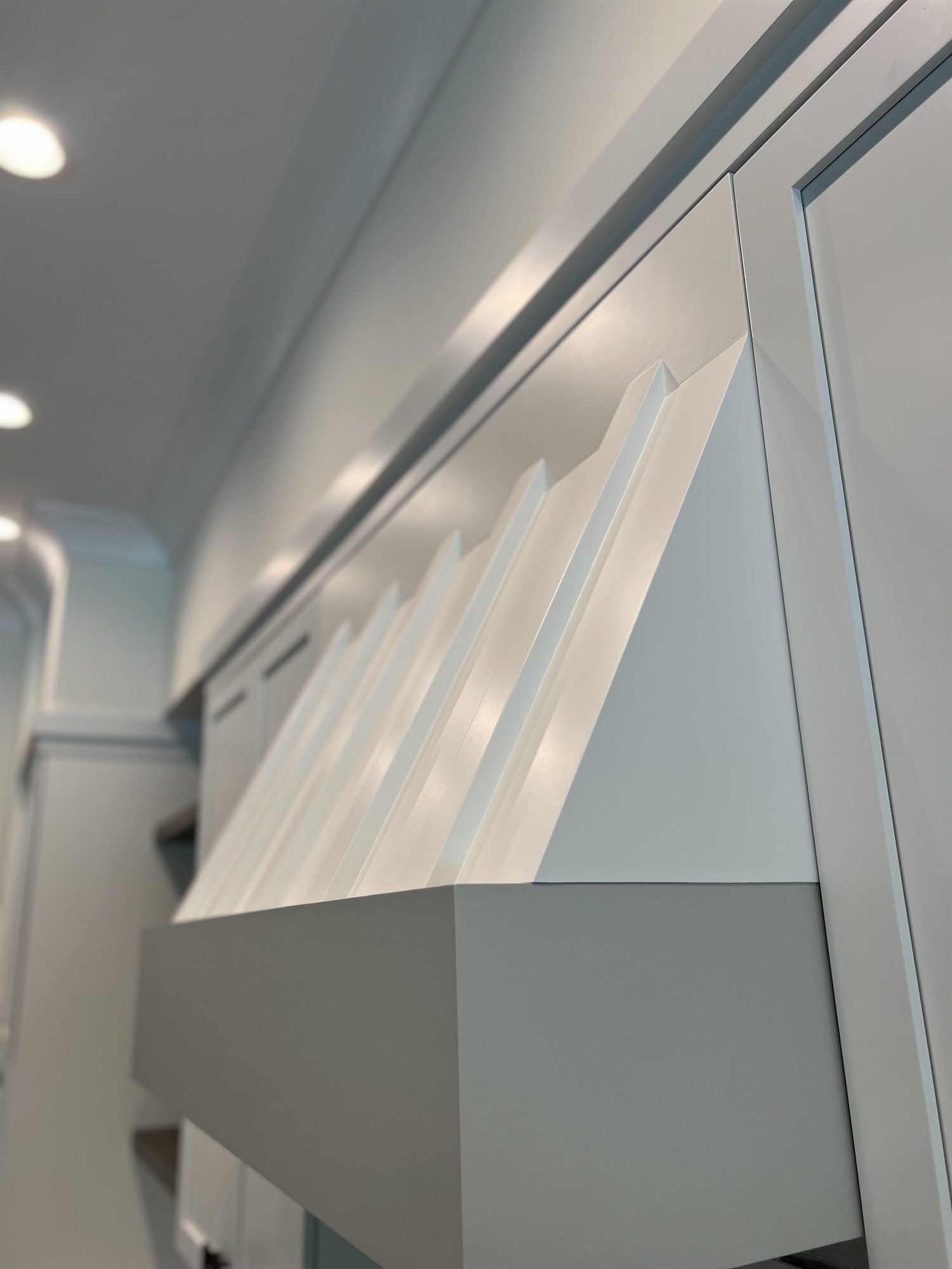 Cabinet crown moulding detail after factory-finish spray