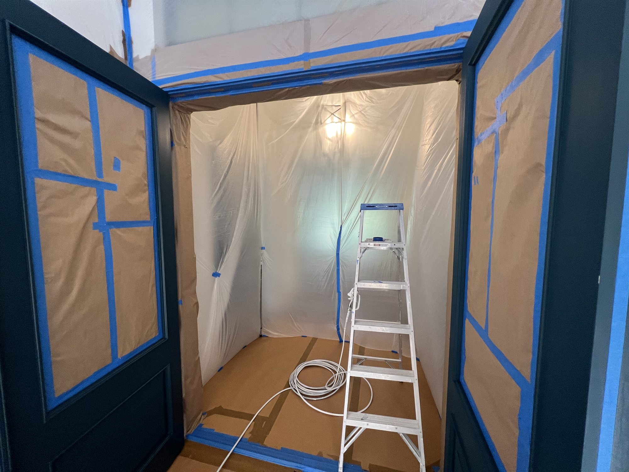 Containment and masking set up before a cabinet spray job